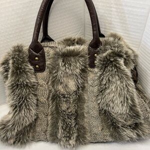 A knitted body and faux fur accents complete the Cable Knit Fur Purse